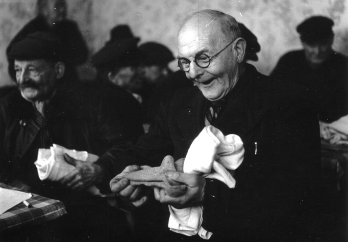 A man receives a pair of socks which were distributed as aid from Ireland in France, 1947. Source: National Archives. 