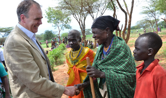 Minister Mc Hugh meets sage recipient with grandchild during his visit to Uganda