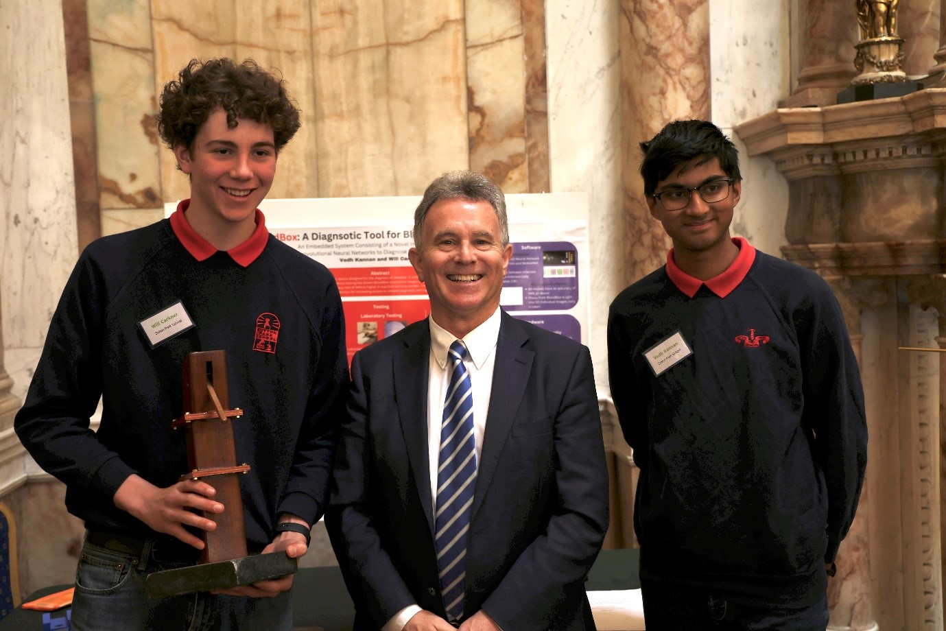 The winners of the 2023 Science for Development award Vedh Kannan and Will Carkner with Minister Fleming